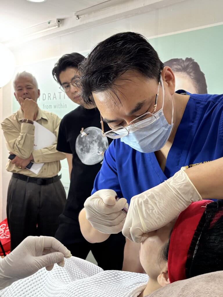 Dr. Tristan demonstrating Neauvia injection techniques to junior doctors during an in-house training session at Da Vinci Clinic.