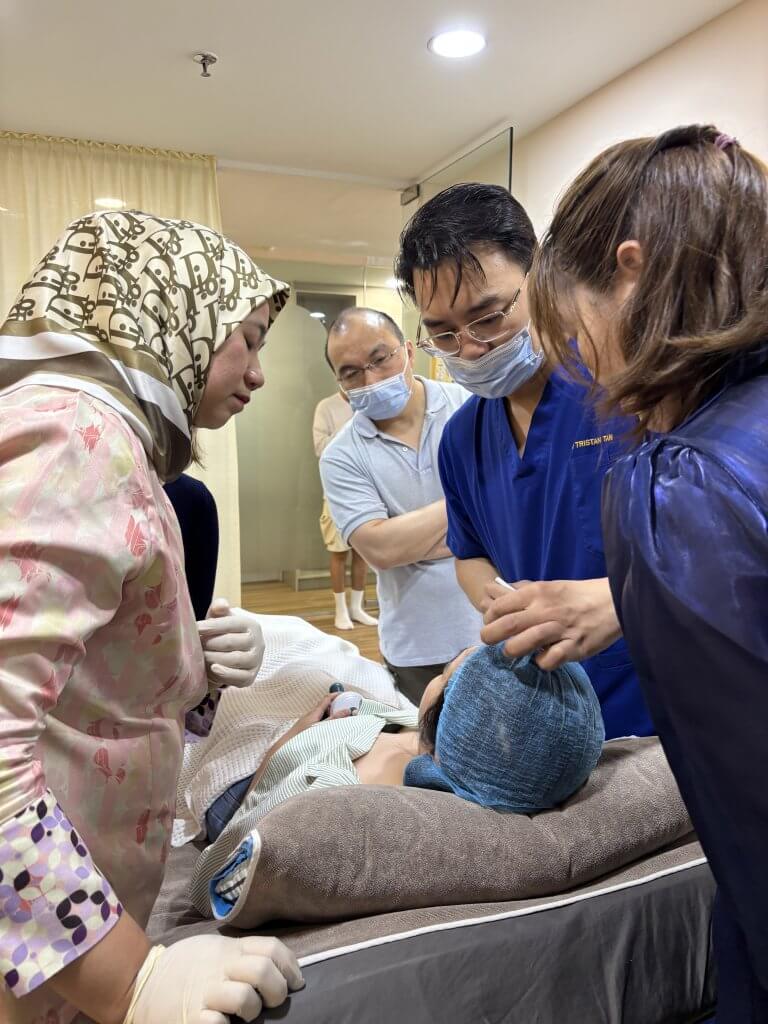 Dr. Tristan and Dr. Wong leading a Botox training session for aesthetic doctors, demonstrating advanced wrinkle relaxation and anti-aging techniques.