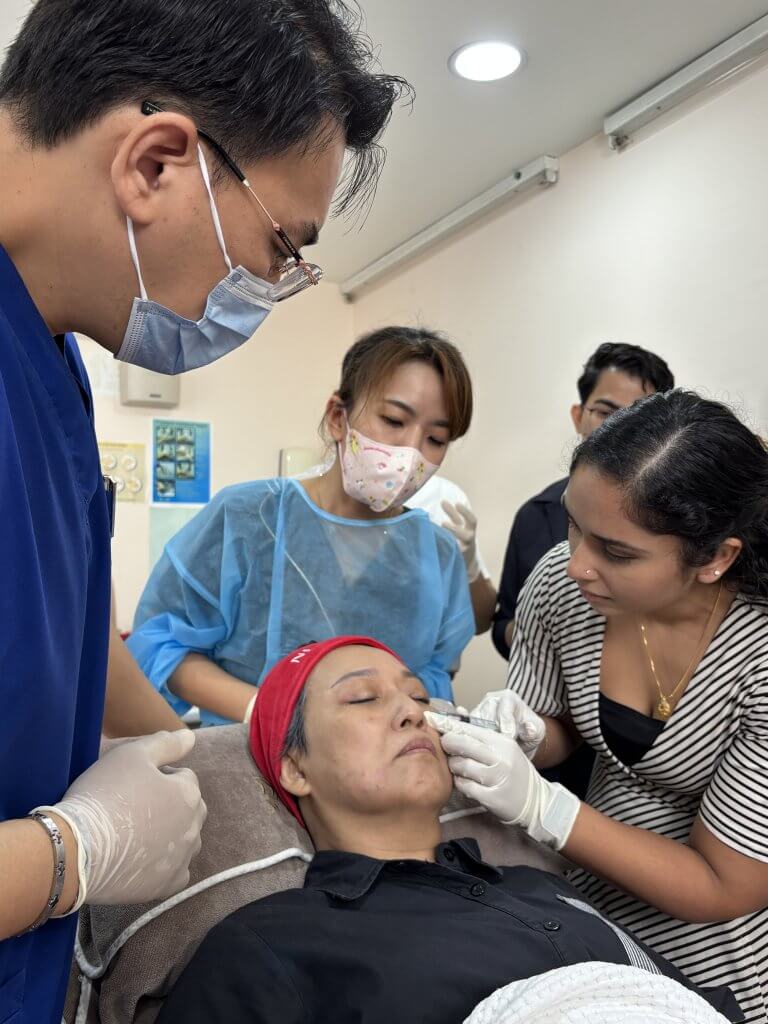 Junior doctors practicing Neauvia injection techniques with Dr. Tristan observing and guiding during a hands-on training session at Da Vinci Clinic.